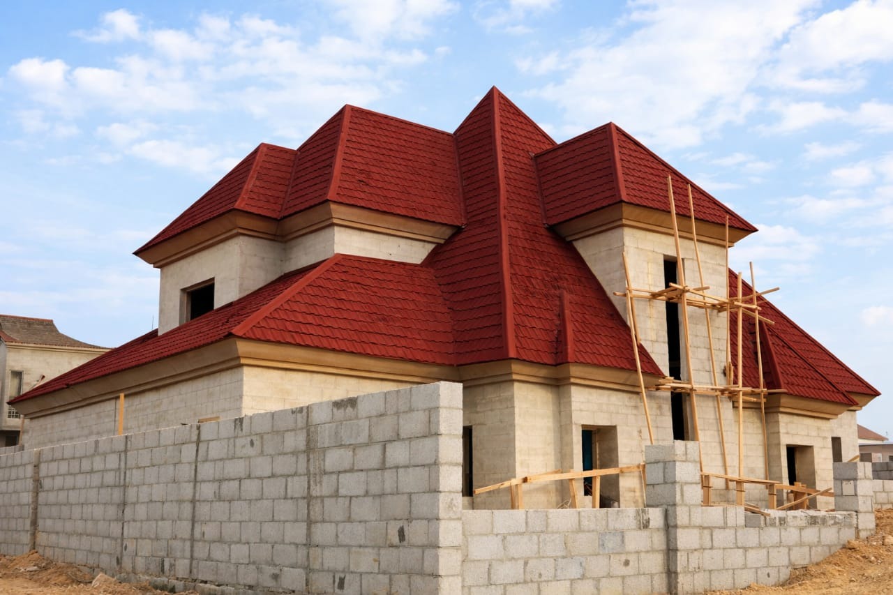 Completed red stone-coated roof on a newly built Abuja home